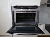 an oven that is built into the wall in the kitchen