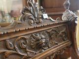 an antique wooden bench with ornate carvings on it in a living room