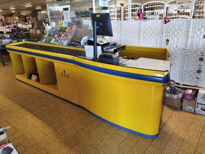a yellow and blue counter in a store with lots of items