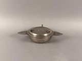 an antique silver plated bowl with a lid and two wings on it