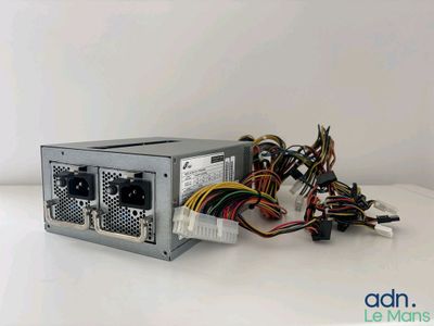 a close up of a computer power supply on a white surface
