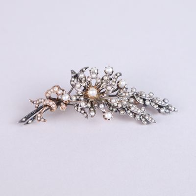an image of a close up of a flower brooch on a white surface