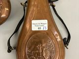 pair of antique copper vases with engraved images on them