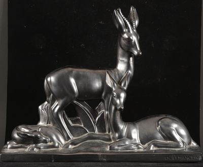 statue of a deer and a baby deer on a black background