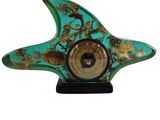 turquoise and gold starfish clock on a black stand