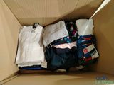 a cardboard box filled with clothes and clothing items