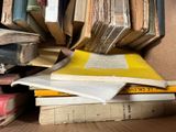 many books stacked on top of each other on a table