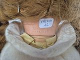 a doll that has a label on it ' s neck