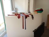 many ties hanging on a wall in a room