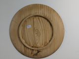 a wooden plate on the wall with a sticker on it