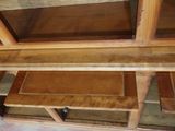 a wooden shelf with glass shelves on it