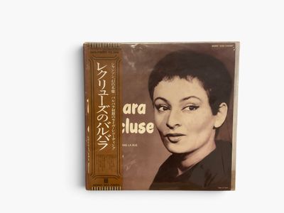 an album with a picture of a woman ' s face on the cover