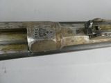 a gun that is on display on a white surface