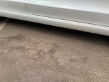 a picture of a white car parked in a parking lot