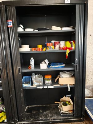 a metal cabinet with a bunch of items on it