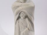 a white statue of a man and a woman holding a baby