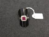 a close up of a ring on a table with a price tag