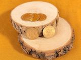 two coins sitting on top of a piece of wood
