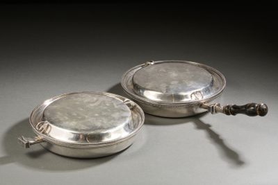 pair of silver plated serving dishes with handles on a table