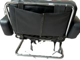 a black leather chair with a black seat and a black bag