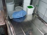 a metal counter with buckets and containers in it