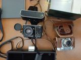 a table with a laptop, camera and other items on it