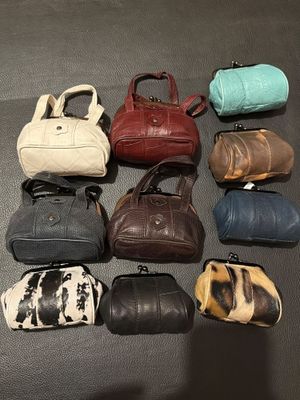 a lot of purses that are sitting on a table