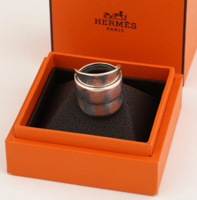 an orange box with a ring inside of it on a white surface