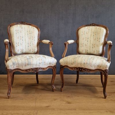 pair of french louis xv style armchairs with upholstered arms