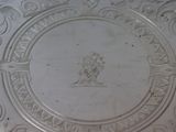 a silver plate with a picture of a man on it