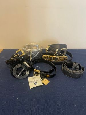several belts and other items are on a blue surface