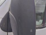 a white van that has a side mirror on the side of it