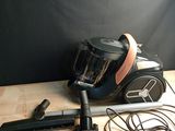 a vacuum that is sitting on a table next to other items