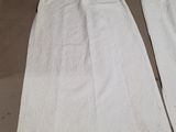 two white towels sitting on top of a table next to each other