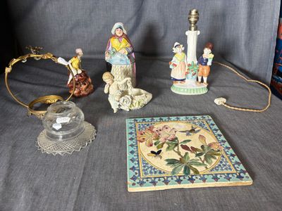 several figurines are displayed on a table next to a book