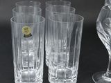 three glasses and a wine glass sitting on a table