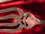 a fork and a spoon sitting on a red cloth
