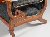 a wooden chair with a blue upholstered upholstered seat