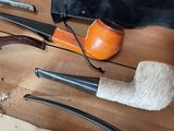 many different types of smoking pipes on the table