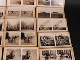 a lot of old black and white photos on a table