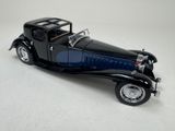 a black model of a car on a white surface