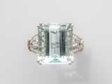 une bague sertie d'une aigue-marine et de diamants sur fond blanc