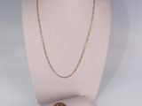 a necklace on a mannequin with a ring on it