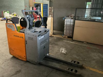 a forklift that is sitting in the middle of a warehouse