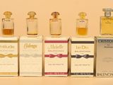 several bottles of different types of perfume sitting next to each other