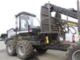 a large truck with a large tractor on the back of it