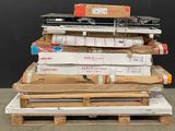 a stack of boxes on a pallet with a laptop on top of it