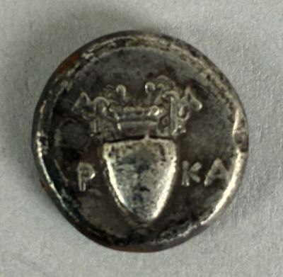 an old coin with a crown and shield on it
