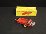 a red toy truck and a red box on a black surface