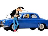 une figurine représentant un homme et un chien assis sur une voiture
